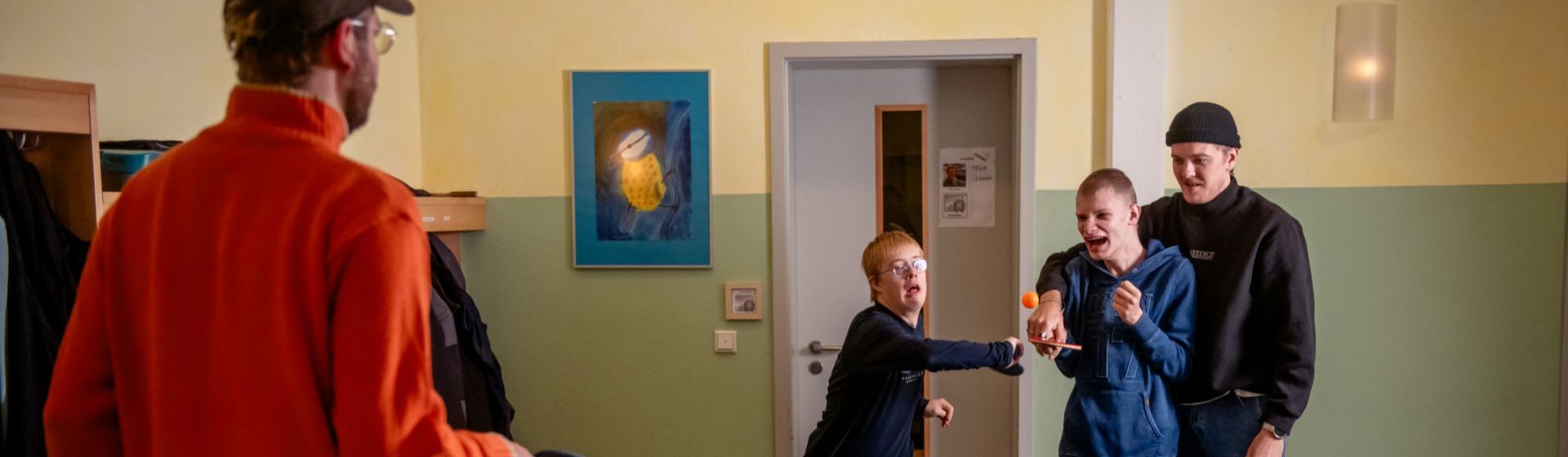 Zwei Betreuer und zwei Kinder beim Tischtennis spielen